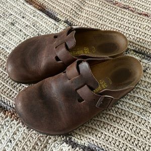 Brown leather hard top Boston Birkenstock clogs.